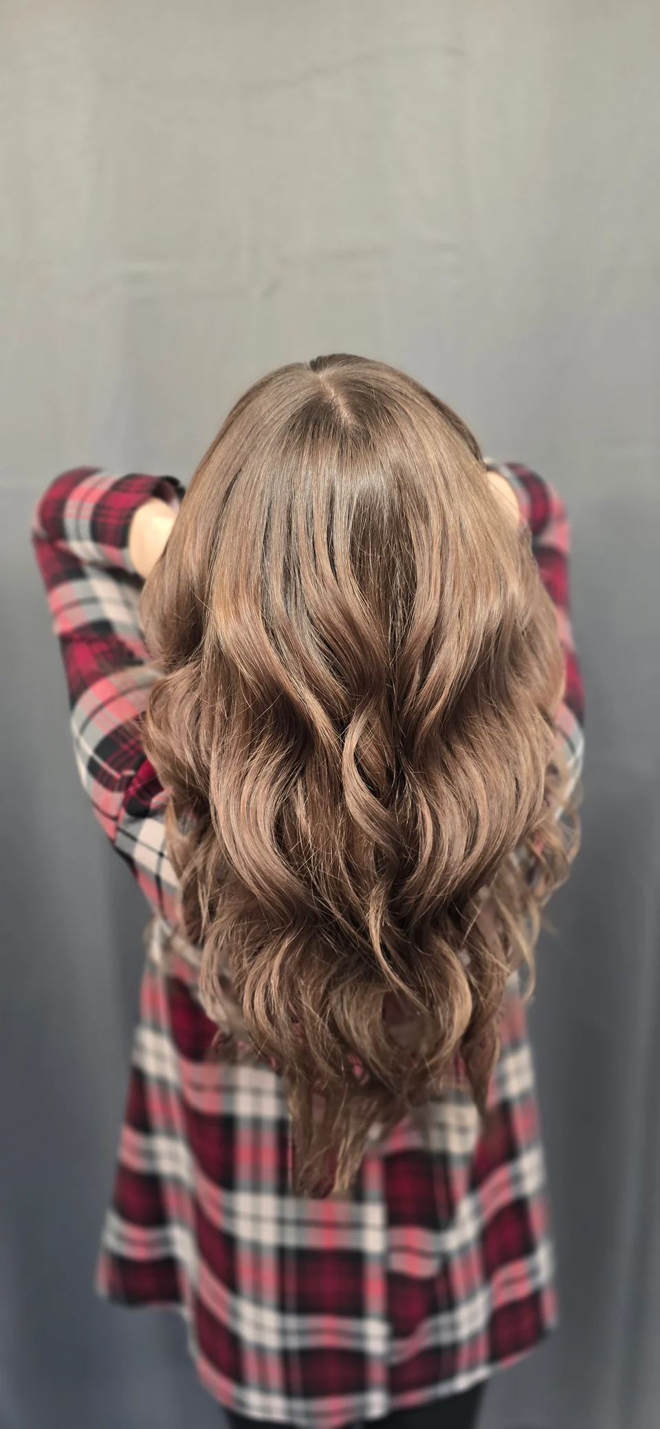 Long hair with softly blended brunette and blonde tones, viewed from behind